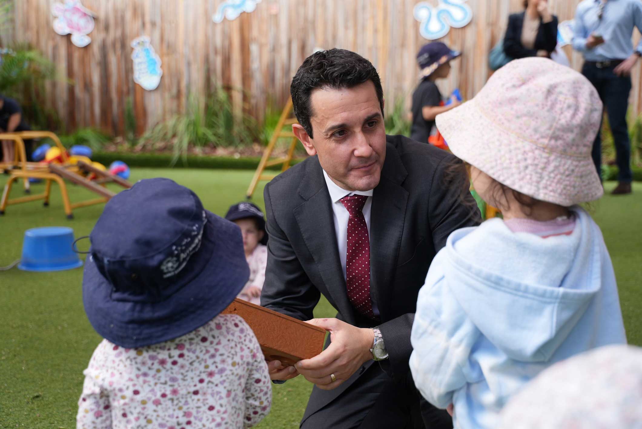 Premier with children at a daycare centre.